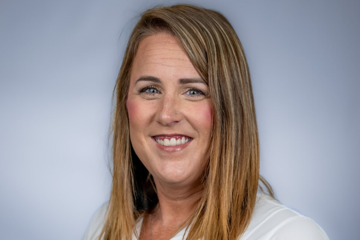Professional photo of Nina for Meet the Team with white shirt, green background and navy overlay