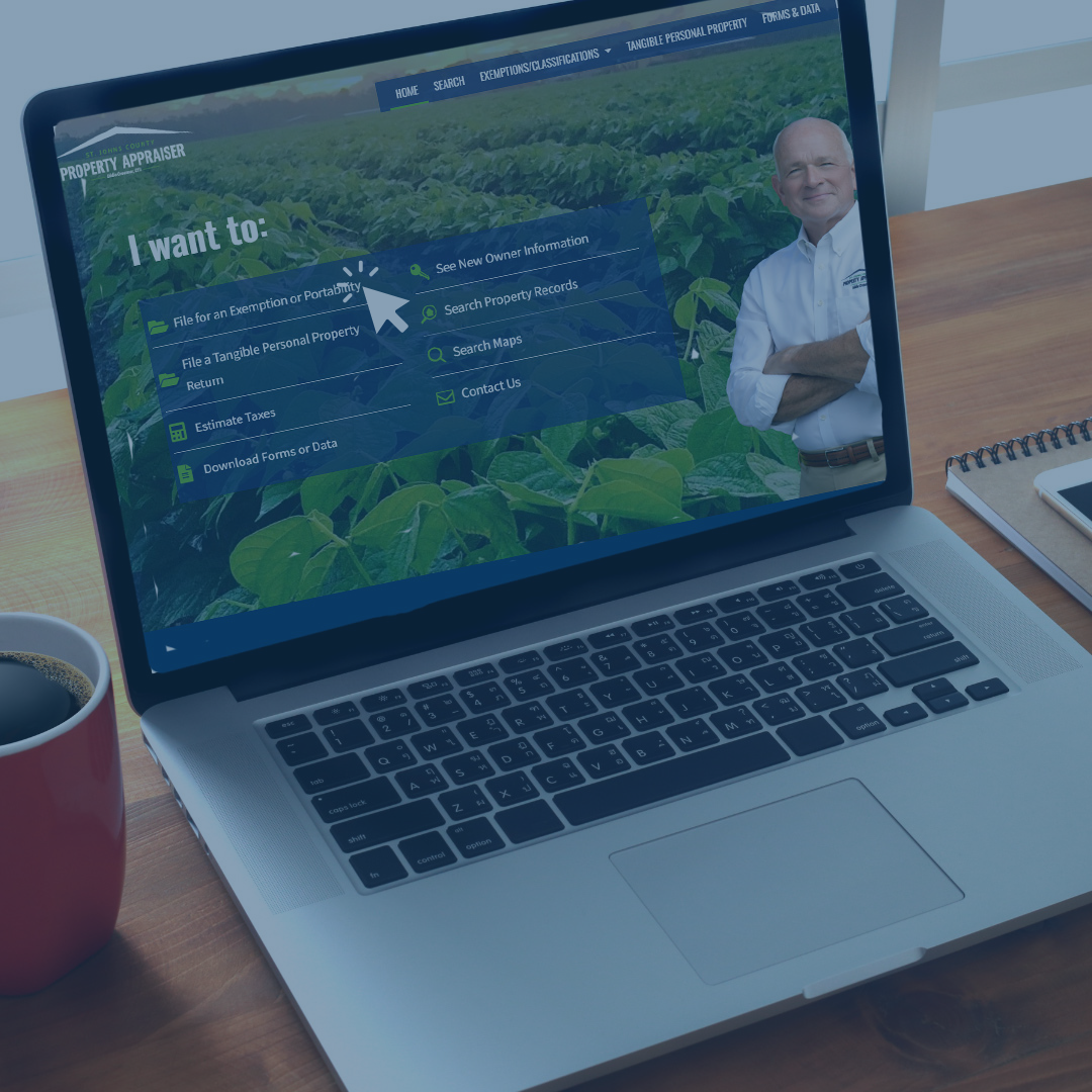 Laptop open with SJC Property Appraiser website showing