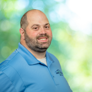 Photo of Mike with blue shirt and green background