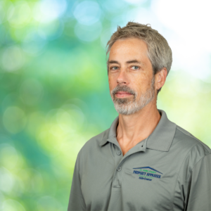 Professional photo of Jason with green background and gray shirt