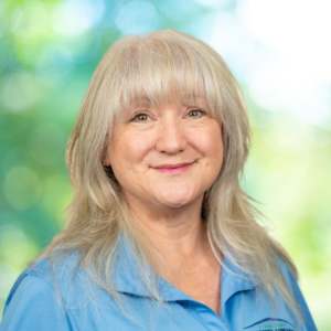 Professional photo of Kim Terrell with blue shirt and green background