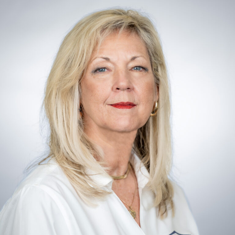 Photo of Cheryl with white shirt and gray background