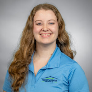 Photo of Rebecca with blue shirt and gray background