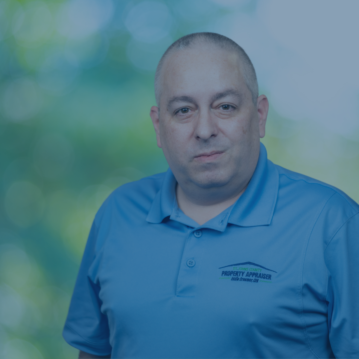 Photo of Ron with blue shirt and navy overlay over photo
