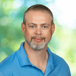 Max with blue shirt and green background