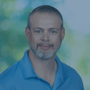 Photo of Max with blue shirt and green background