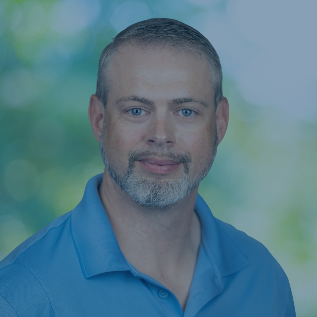 Photo of Max with blue shirt and green background