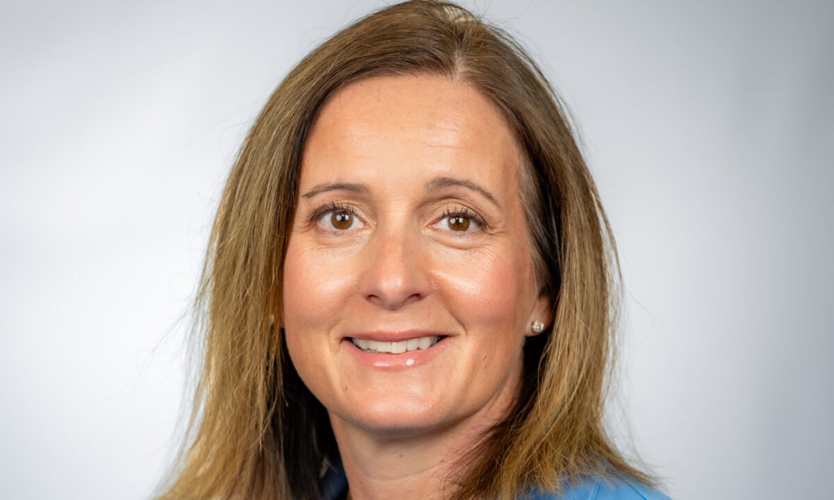 Photo of Charity from neck up looking at camera with gray background