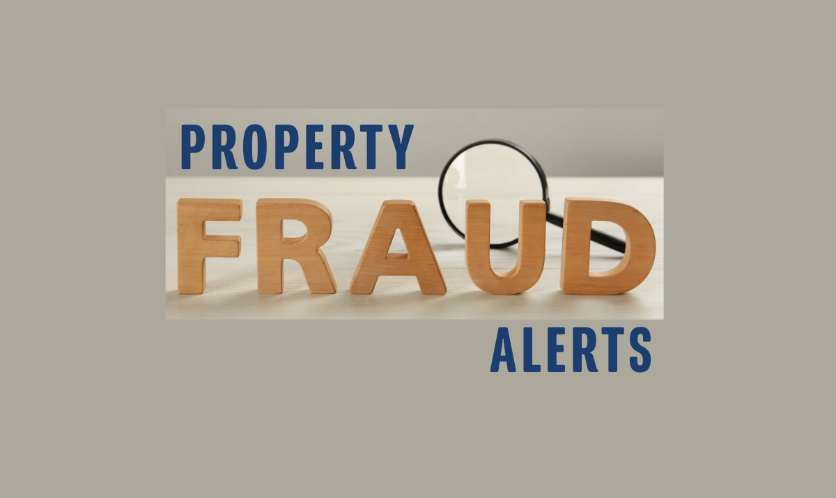 Fraud is spelled out in wooden letters with magnifying glass behind the letters with the word property added to the top and alerts added to the bottom